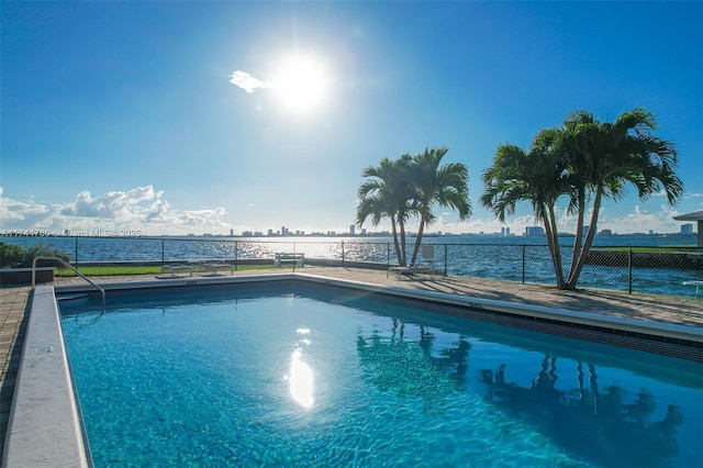 view of swimming pool featuring a water view