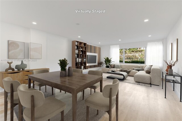 dining room with light wood finished floors and recessed lighting