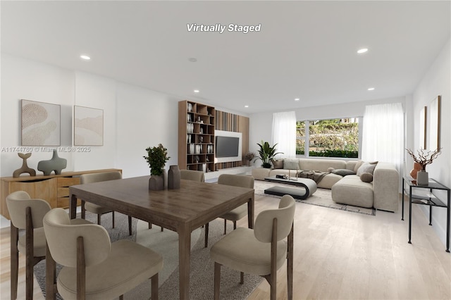 dining room featuring light wood-style flooring and recessed lighting