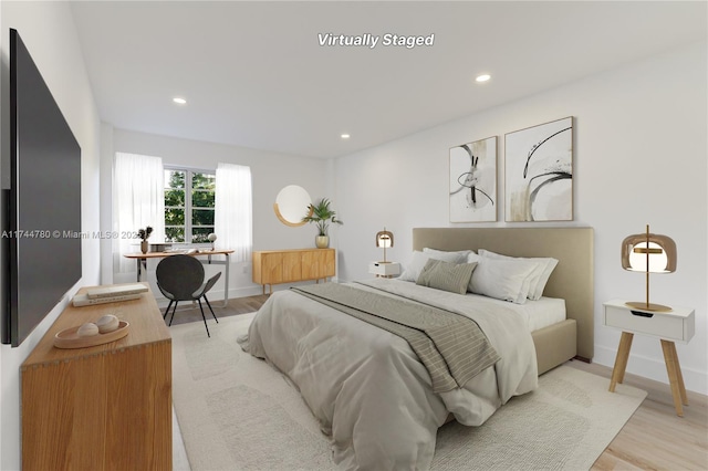 bedroom with baseboards, recessed lighting, and light wood-style floors