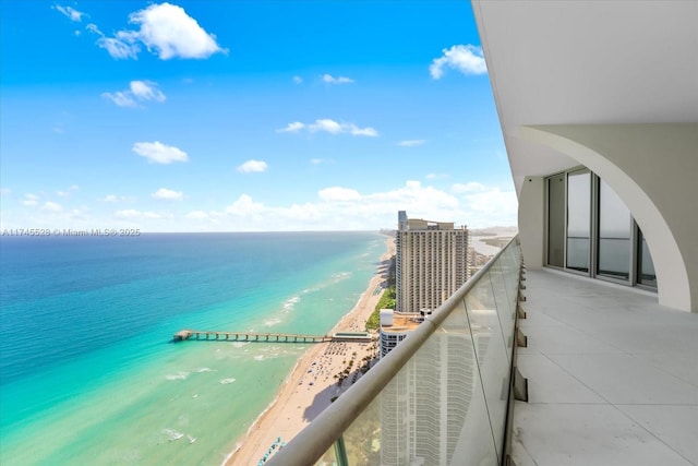 balcony with a beach view and a water view