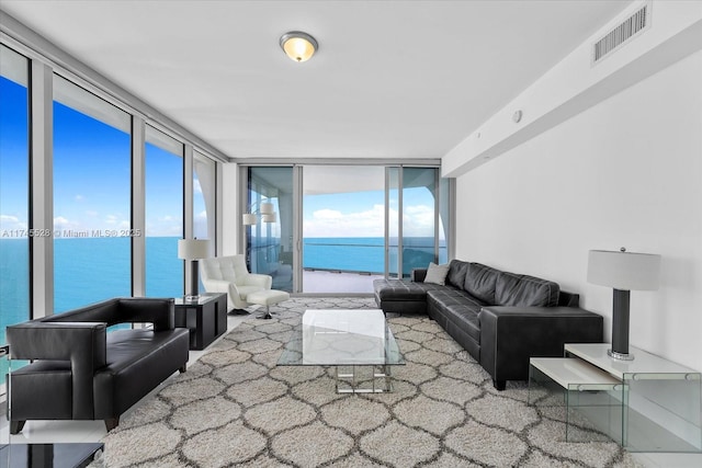 living room featuring a water view and floor to ceiling windows