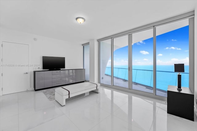 living room with floor to ceiling windows and light tile patterned floors