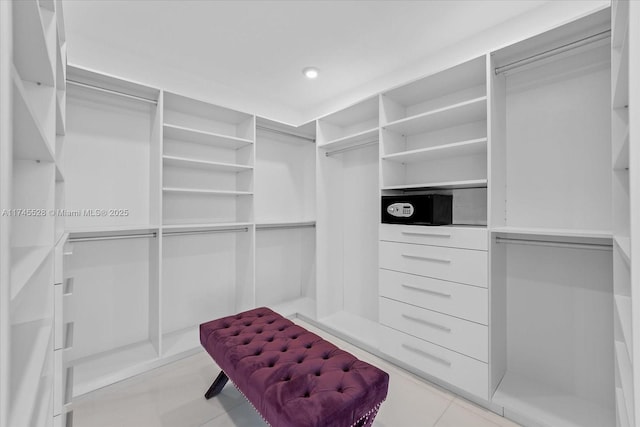 walk in closet featuring light tile patterned flooring