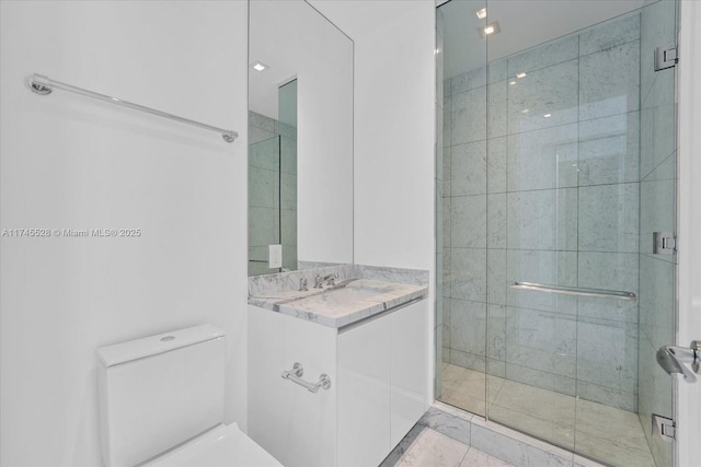 bathroom featuring vanity, an enclosed shower, and toilet