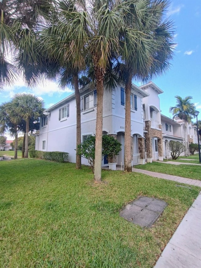 view of home's exterior featuring a lawn and stucco siding