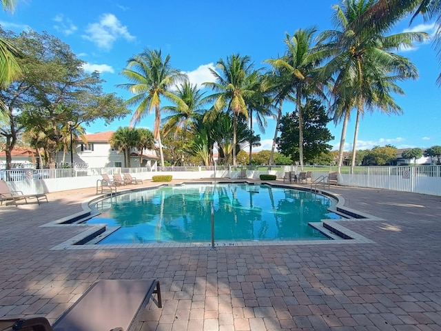 pool featuring fence and a patio