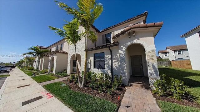 mediterranean / spanish-style home with a front yard