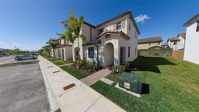 mediterranean / spanish-style home featuring a front lawn