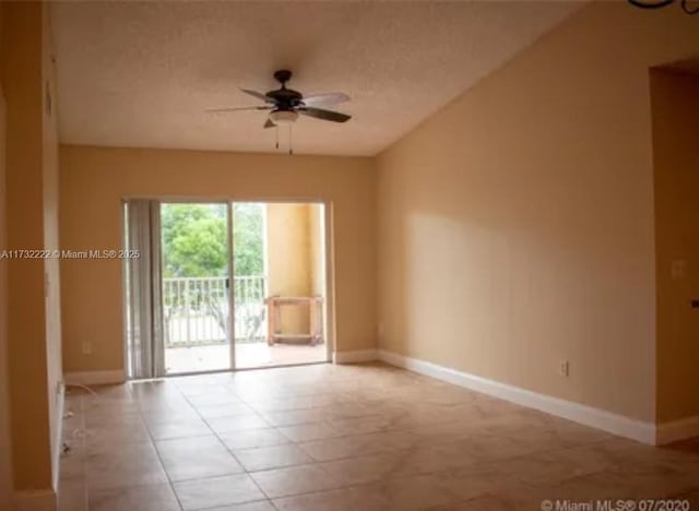 tiled empty room with a textured ceiling and ceiling fan