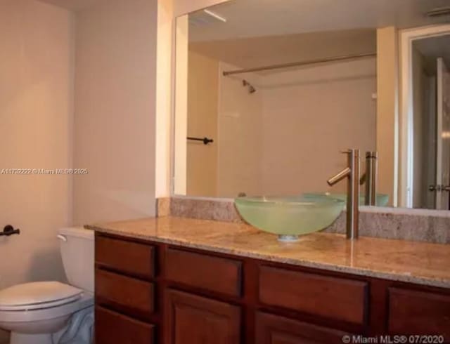 bathroom with vanity and toilet