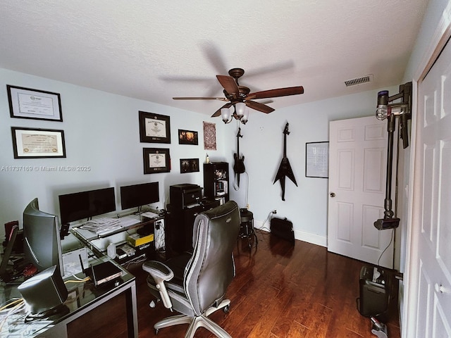 office space featuring dark hardwood / wood-style floors, a textured ceiling, and ceiling fan