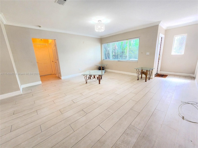 unfurnished room featuring baseboards, a healthy amount of sunlight, light wood-style flooring, and crown molding