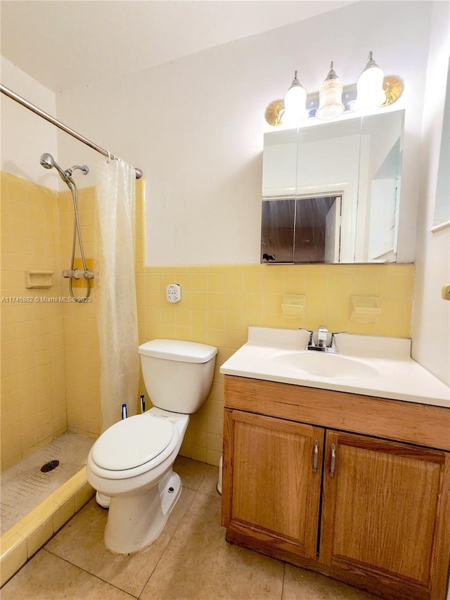 full bathroom featuring toilet, tile patterned floors, vanity, a shower stall, and tile walls