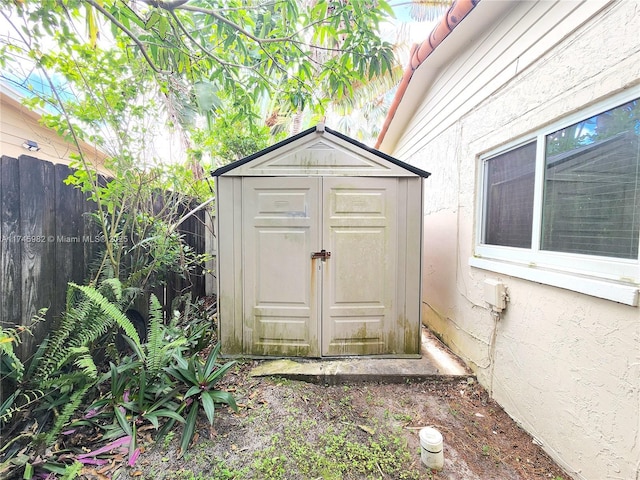 view of shed featuring fence