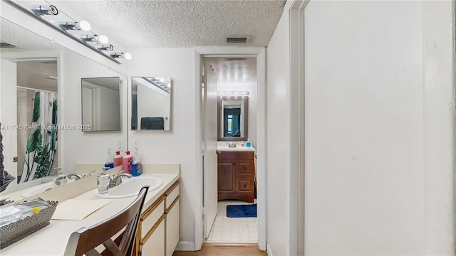 bathroom featuring vanity and a textured ceiling