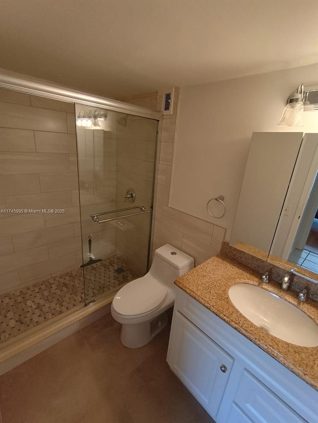 bathroom with vanity, walk in shower, and toilet