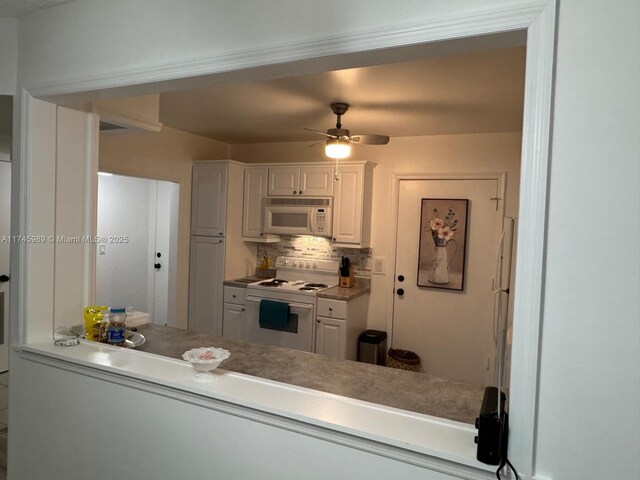 4770 NW 21st St Unit 208, Lauderhill, FL 33313 - kitchen featuring white appliances, white cabinets, a ceiling fan, and backsplash