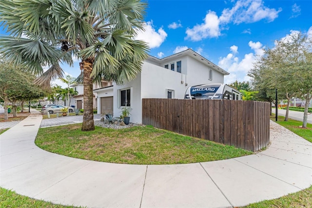 view of property exterior with a garage and a yard