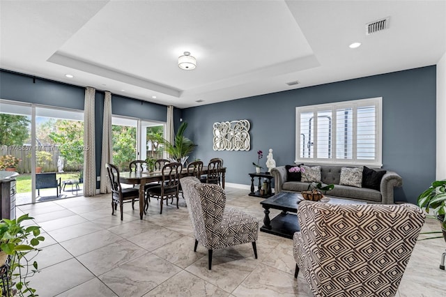 living room with a tray ceiling