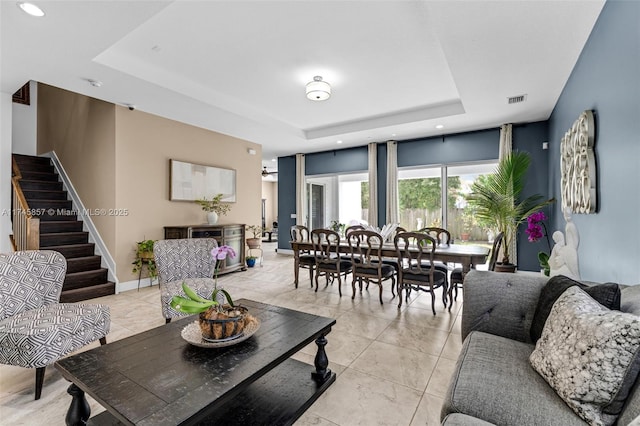 living room featuring a raised ceiling