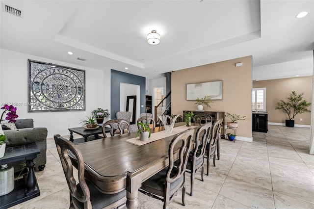 dining area with a tray ceiling