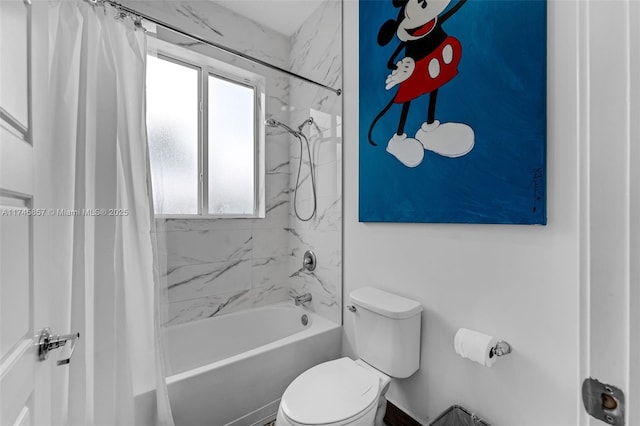 bathroom featuring shower / tub combo and toilet