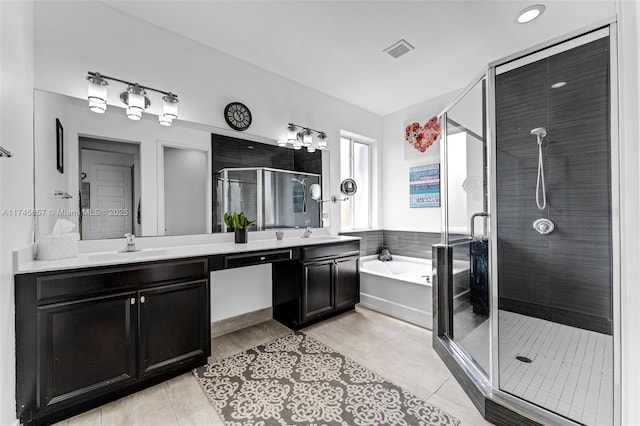 bathroom with tile patterned flooring, plus walk in shower, and vanity