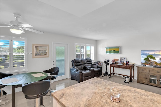 tiled living room with ceiling fan