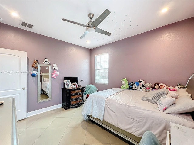 bedroom with a ceiling fan, visible vents, baseboards, and light tile patterned floors