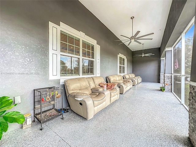 exterior space featuring a ceiling fan and speckled floor