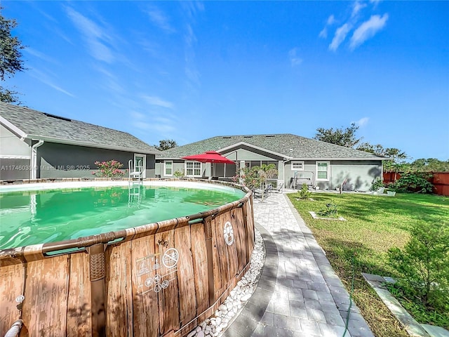 pool with a yard and fence