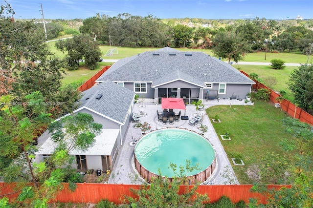 exterior space with a fenced in pool, a patio area, a sunroom, and a fenced backyard