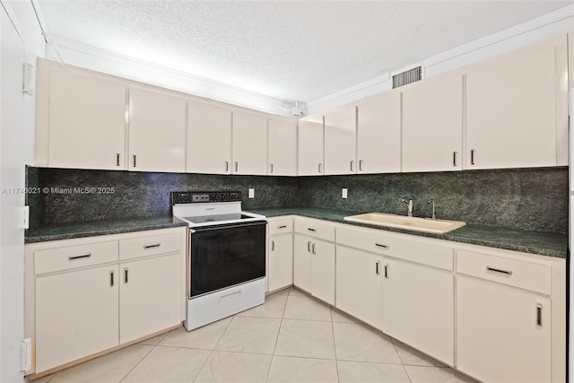 kitchen with dark countertops, a sink, a textured ceiling, electric stove, and visible vents