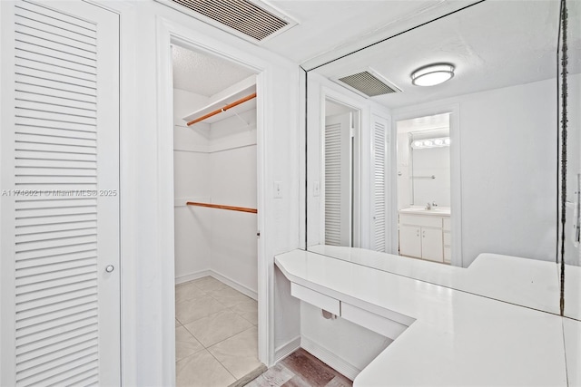 spacious closet featuring visible vents
