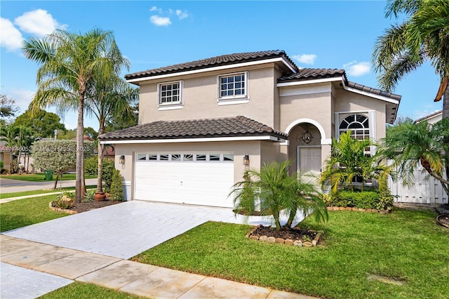 mediterranean / spanish home featuring a garage and a front lawn