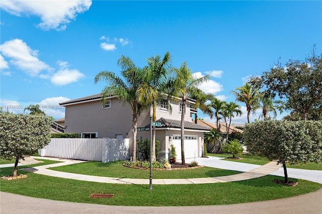 view of side of home featuring a garage and a lawn