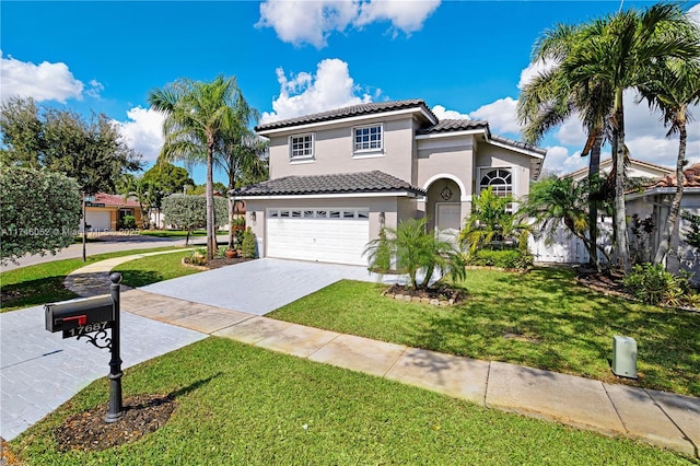 mediterranean / spanish house with a garage and a front yard