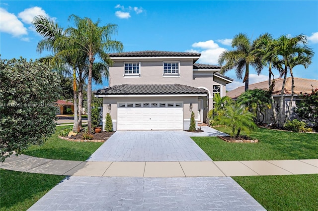 mediterranean / spanish-style house featuring a garage and a front lawn