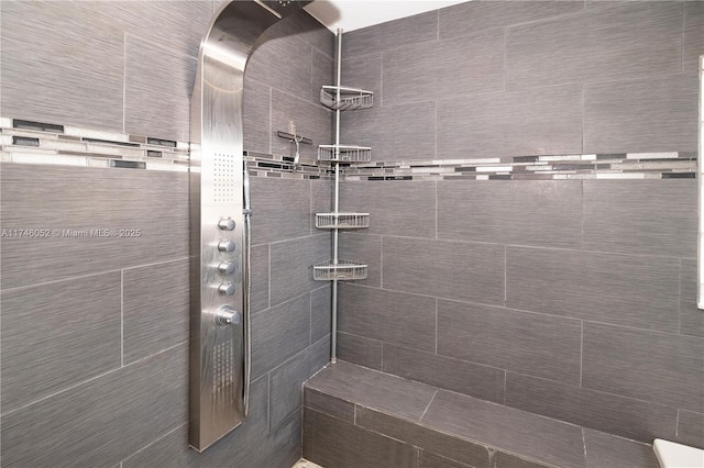 bathroom with a tile shower