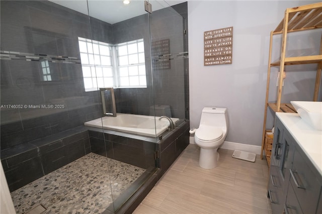 full bathroom featuring vanity, separate shower and tub, and toilet