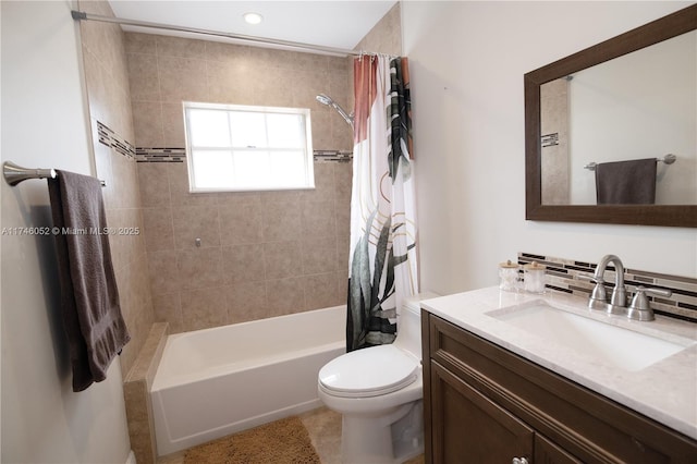 full bathroom featuring vanity, tasteful backsplash, shower / bath combination with curtain, and toilet