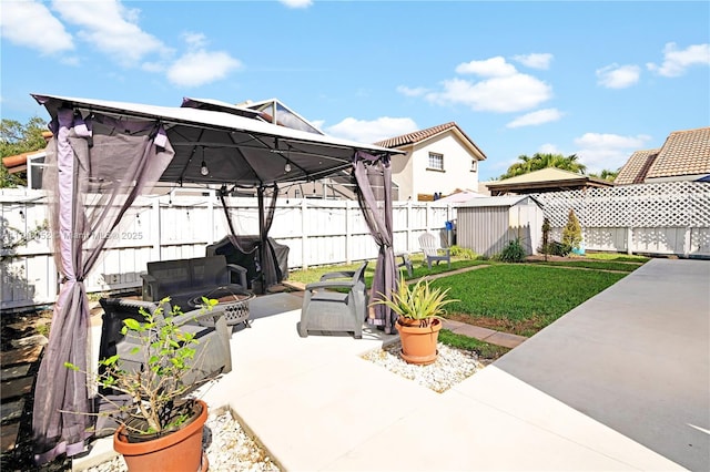 view of patio with a shed, a gazebo, grilling area, and outdoor lounge area