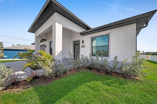 contemporary home with a front lawn