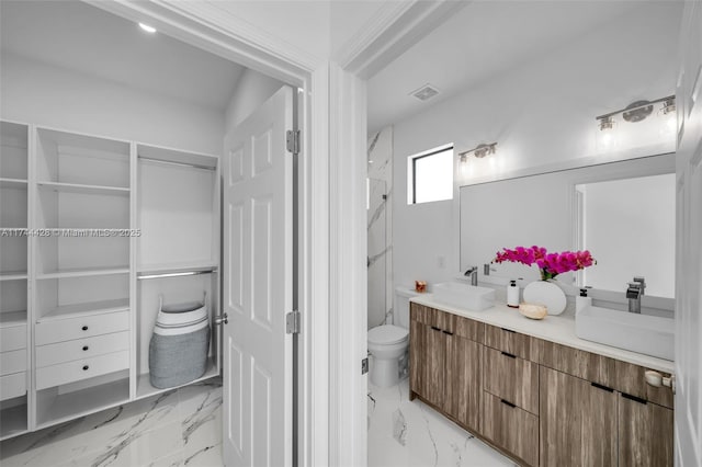 bathroom featuring vanity and toilet