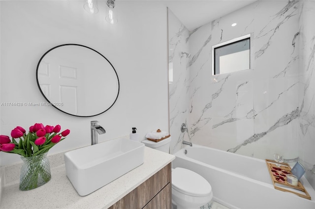 full bathroom featuring vanity, toilet, and tiled shower / bath combo