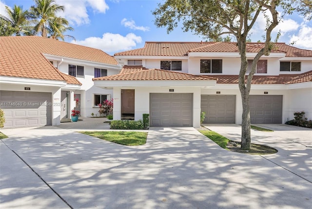 mediterranean / spanish-style house with a garage