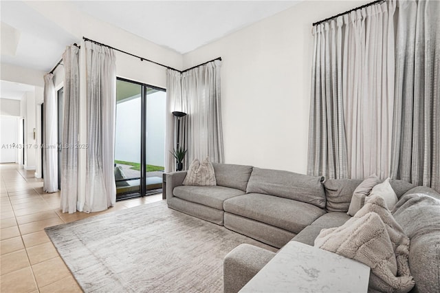 living room featuring a wealth of natural light and light tile patterned floors