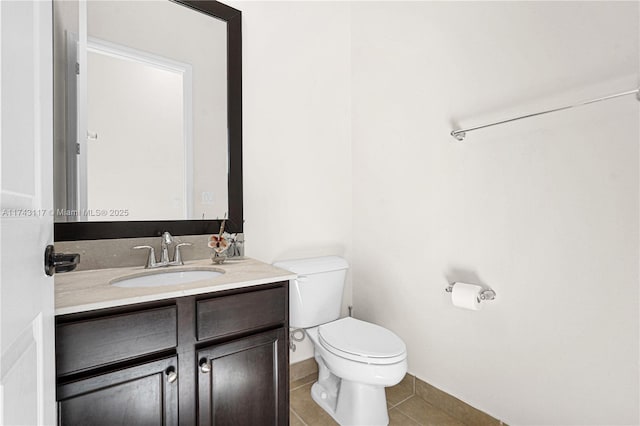 bathroom featuring vanity, tile patterned floors, and toilet