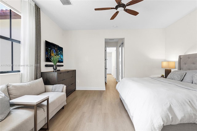 bedroom with light hardwood / wood-style flooring and ceiling fan